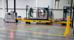 JBT towing AGV in auto manufacturing facility