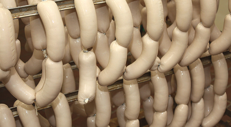 Clipped string sausages on racks