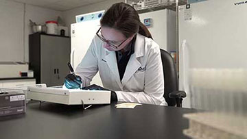 Lab Technician Writing Over Table